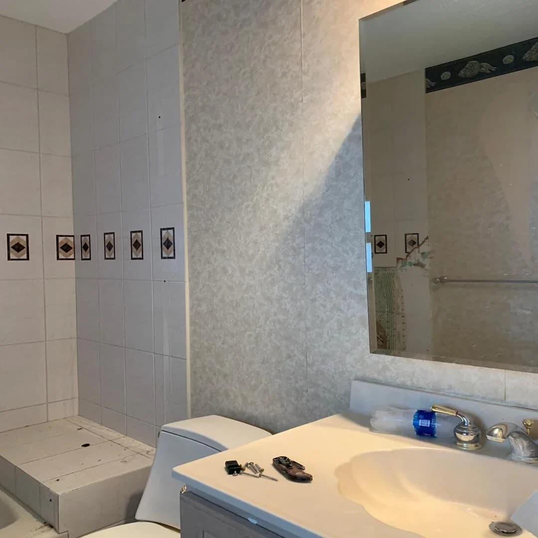 Bathroom vanity and framed mirror by JC General Painting in South Florida