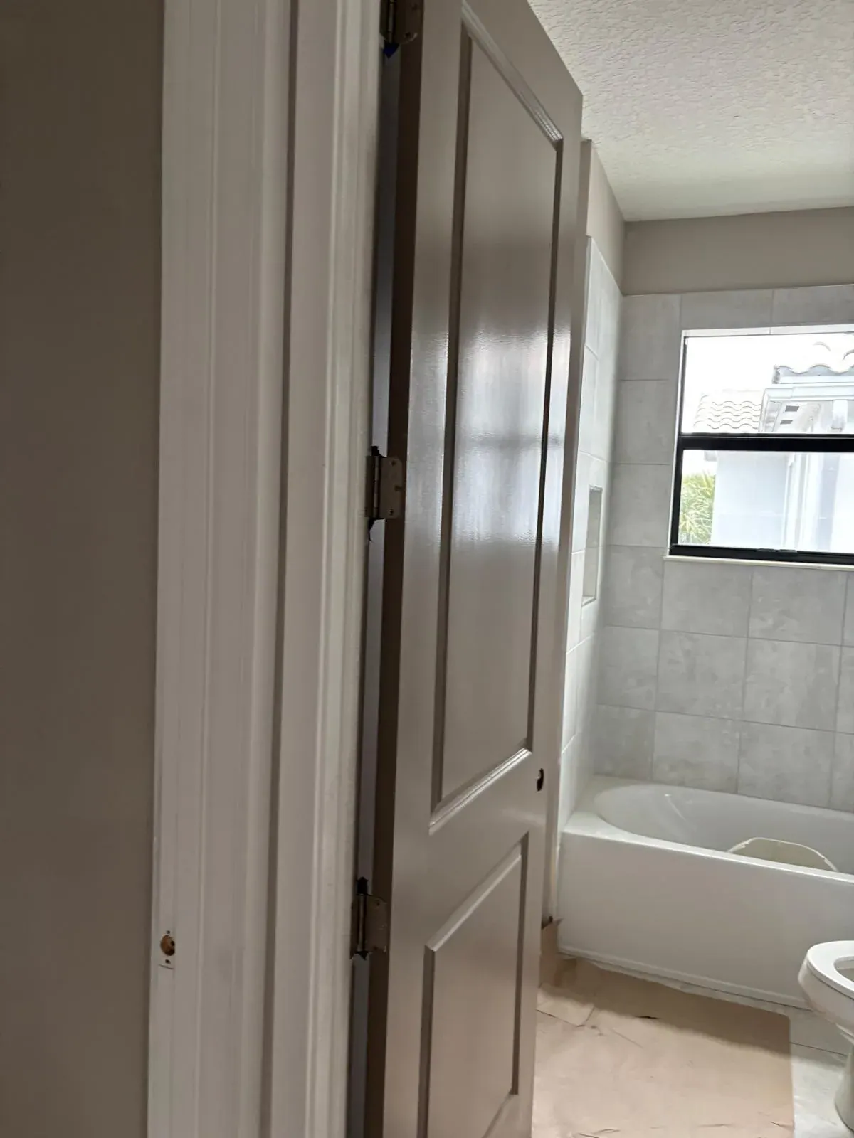 Bathroom Painting Grey Door Tub Delray Beach by JC General Painting in South Florida