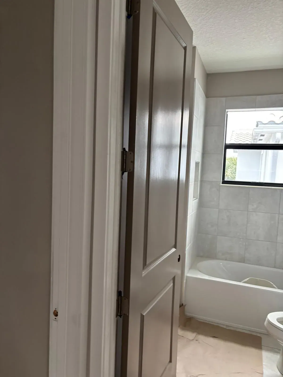 Bathroom Painting Grey Door Tub by JC General Painting in South Florida