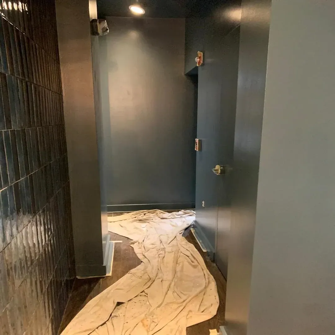 Dark tile feature wall and interior door by JC General Painting in South Florida