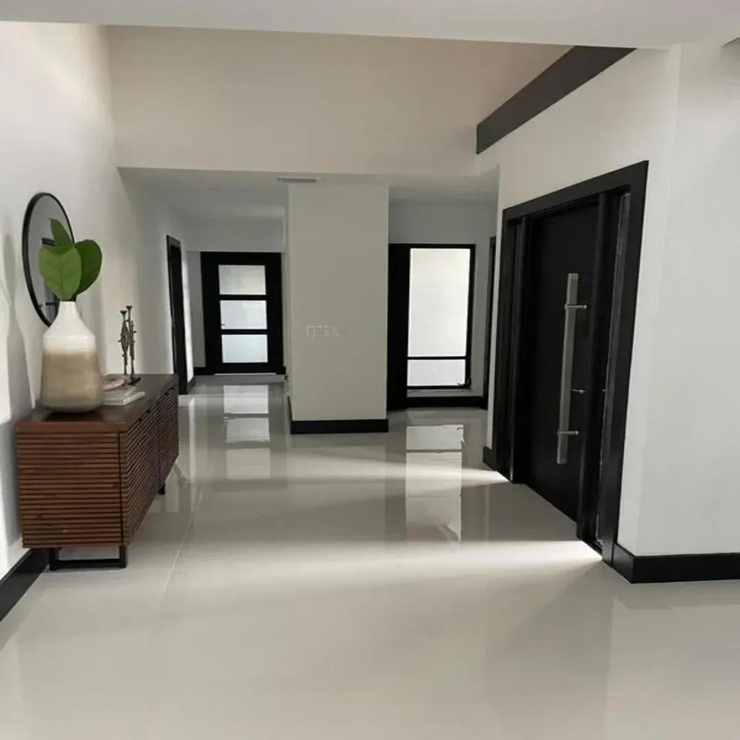 Bright modern interior entry and living space by JC General Painting in South Florida